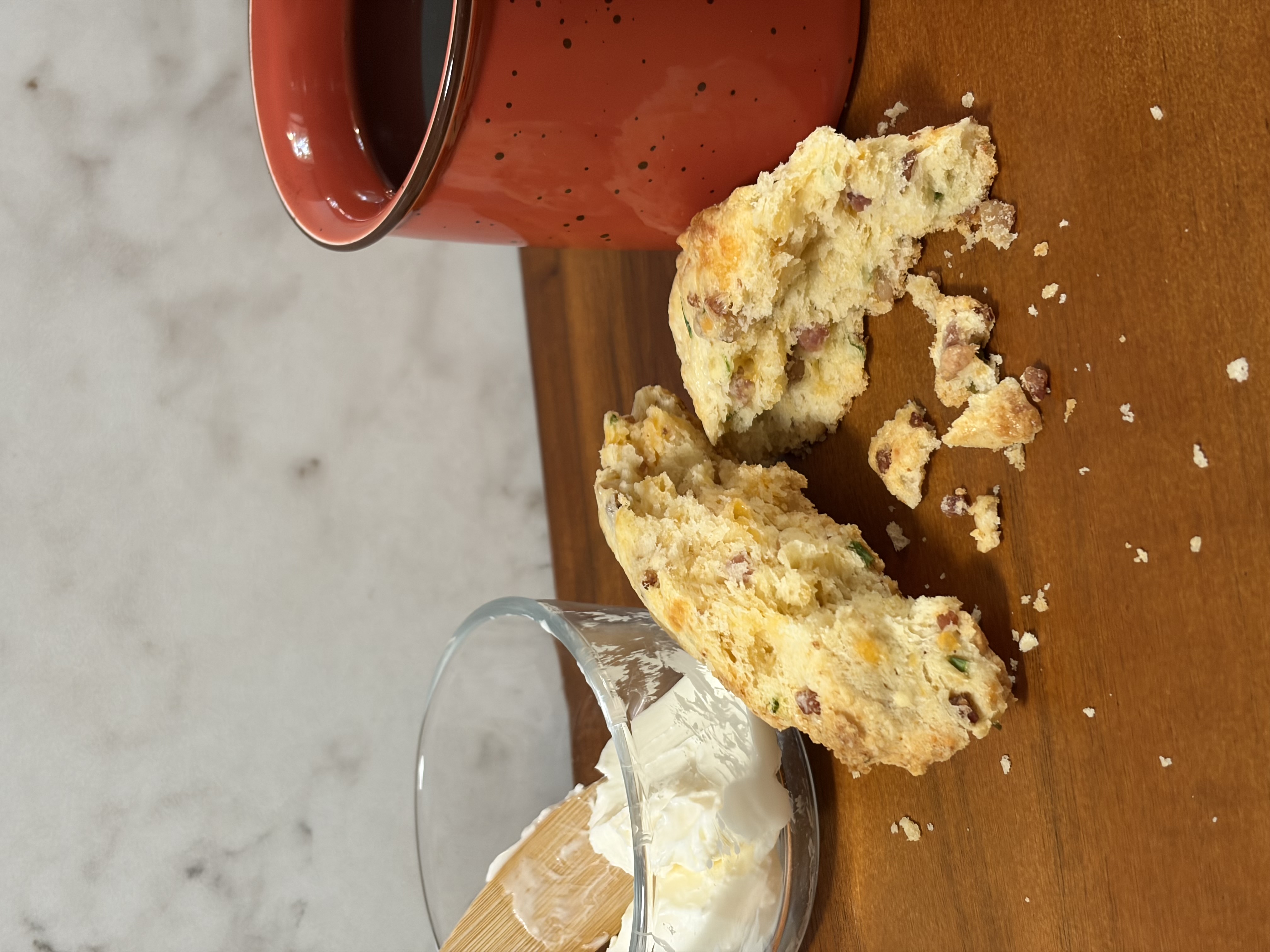 Bacon, cheddar and chive scones with butter and coffee.